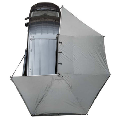 Image of the OVS Nomadic 270° Awning with the optional zip-in wall deployed, showing a top-down view of the gray fabric and the additional wall for a fully enclosed shelter