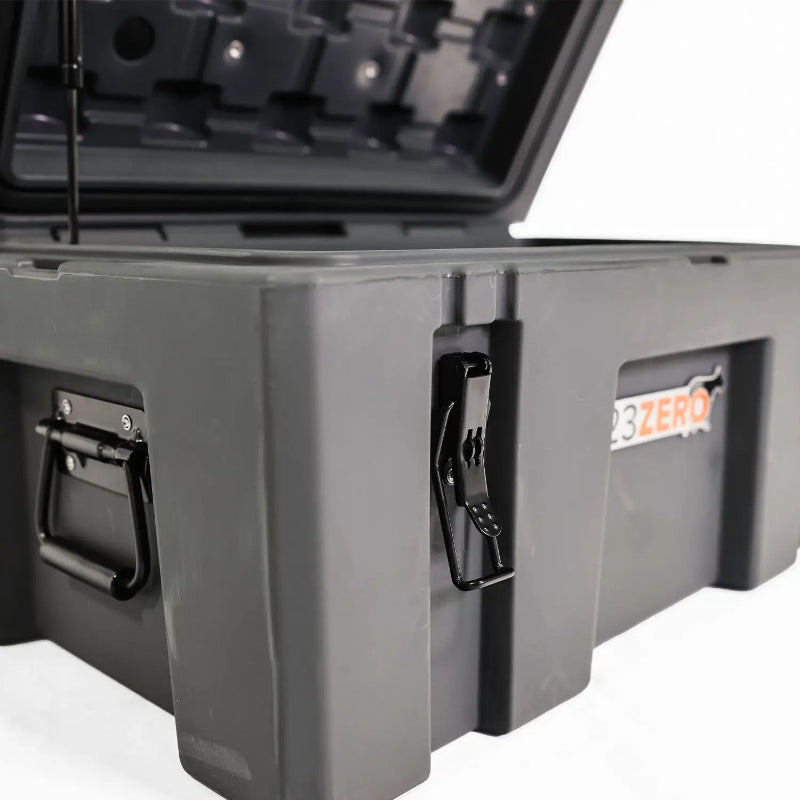 Image of a close-up of a black latch and handle on a grey 23ZERO storage box with the lid open, angled side view on a white background.