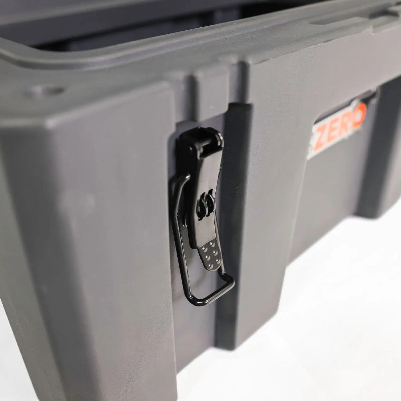 Image of a close-up of a black latch on a grey 23ZERO storage box, angled side view on a white background.