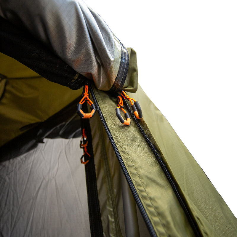 Image of a close-up detail of the 23ZERO Armadillo A2 Plus rooftop tent annex room, showing the top of the zippered entrance with three black and orange pulls. The photo highlights the heavy-duty zippers and detailed stitching