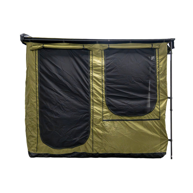 Image of a 23ZERO Bushman 78 Awning with the optional awning room attached, on a white background. The front view shows the green fabric room with two large black mesh windows