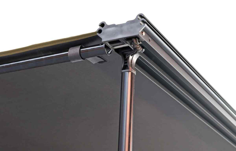 Close-up image of the corner of a deployed Peregrine Awning, showcasing the black support pole, the dark fabric underside, and the robust metal framework. The detailed view highlights the structural components against a clean white background