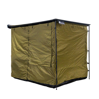 Image of a fully enclosed Bushman awning room with all windows zipped shut, showcasing its solid green fabric construction. The room is viewed from an angled front and side perspective on a white background