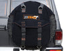 Image of a black 23ZERO spare tire storage bag with orange accents and grey straps, mounted on the rear spare tire of a grey SUV, with the vehicle's taillight and bumper visible.