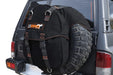 Image of a black 23ZERO spare tire storage bag with orange stitching and black straps, mounted on the rear spare tire of a dark grey SUV, shown from a slight angle.