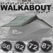 Image of a dark green flysheet draped over a partially deployed roof top tent, with "MADE FOR WALKABOUT" text and paw prints at the top, and numbered circles "56, 62, 72, 87" at the bottom.