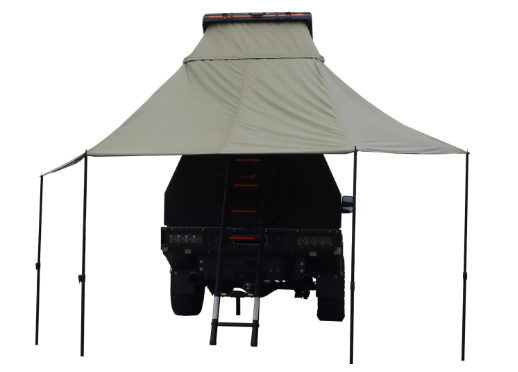 Image of a light tan rooftop tent with an attached awning deployed over the rear of a dark off-road vehicle, featuring a ladder extending to the ground, rear view on a white background.