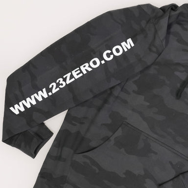 Image of 23ZERO black camo hoodie sleeve with bold white website logo print, close-up angled view on white background.