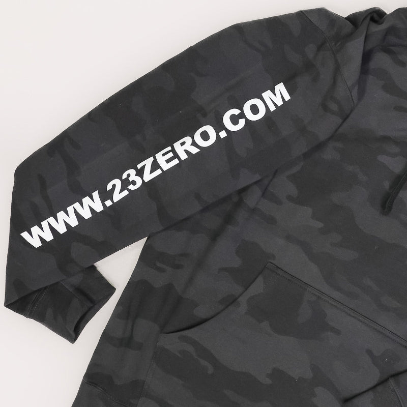 Image of 23ZERO black camo hoodie sleeve with bold white website logo print, close-up angled view on white background.