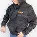 Image of 23ZERO black camo pullover hoodie worn by model with front kangaroo pocket and chest logo, angled front lifestyle view on white background.