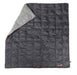 Image of a 23ZERO Camping Quilted Blanket, dark grey with a light grey folded corner and orange trim, shown flat on a white background.