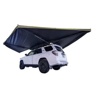 Image of a white Toyota 4Runner with a 23Zero Peregrine 270 Pro Awning fully deployed in a freestanding setup. The awning, with its khaki top and black underside, extends over the side and rear of the vehicle, shown from a rear three-quarter view on a white background