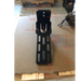 Image of black metal awning mounting bracket with elongated slotted holes and bolt points, shown with red measurement annotations indicating detailed dimensions, front-facing view on a cardboard background.