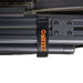 Image of a close-up detail of the Peregrine PRO 180 Awning with the awning arm strapped to the frame for storage. The black webbing strap has the 23ZERO logo embroidered in orange, highlighting the quality and branding of the product's hardware