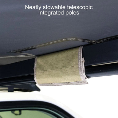 Image of a close-up, high-angle view of the underside of a 23ZERO Peregrine 180 Compact Awning. A green fabric loop holds the neatly stowed telescopic integrated poles against the black awning frame