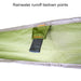 Image of a close-up on the green fabric of a 23ZERO Peregrine Awning, showcasing a reinforced black webbing tiedown loop. The loop is securely stitched with orange thread, providing a point for rainwater runoff