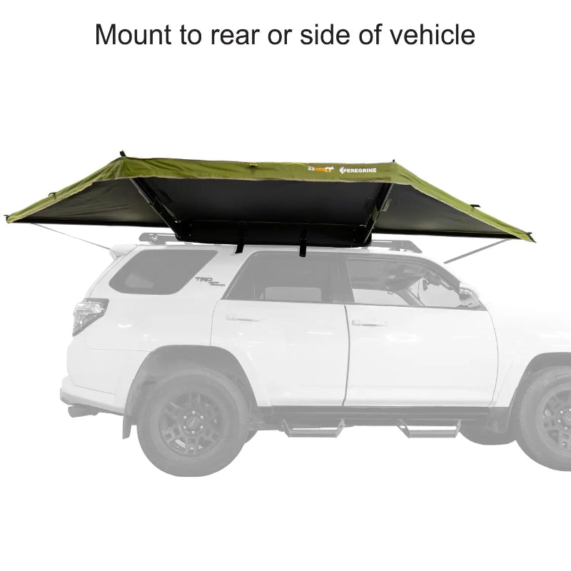 Image of a 23ZERO Peregrine 180 Compact Awning partially deployed from the rear of a vehicle. The awning features green fabric with a black underside and is mounted on a white vehicle with a roof rack