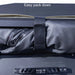 Image of a 23ZERO Peregrine 180 Compact Awning being packed away, with a black strap holding the rolled-up green fabric and black underside against the awning frame. The product is shown from a close-up, top-down view