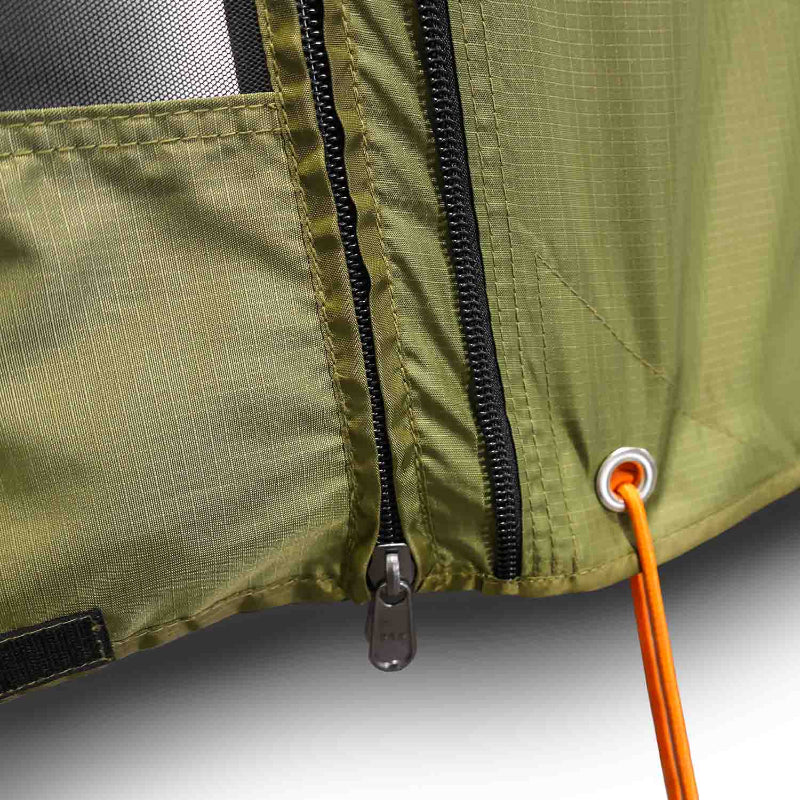 Close-up image of olive green tent or awning fabric with a black zipper, a zipper pull, and an orange guy rope attached through a metal grommet