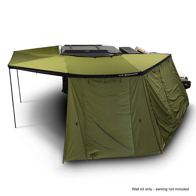 Image of the OVS Peregrine Pro 270-degree awning partially deployed with olive green solid walls on two sides, creating a covered shelter next to a vehicle, with a note 'Wall kit only - awning not included' at the bottom, all on a white background