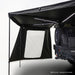 Image of an OVS Nomadic 270-degree awning with two black walls deployed, one with a large white panel, LED lights underneath, attached to the rear of an off-road vehicle, with a note 'Wall kit only - awning not included' at the bottom, all on a white background