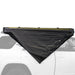 Image of Peregrine Pro 5-arm awning partially deployed, black fabric with green underside, angled side view on vehicle with white background