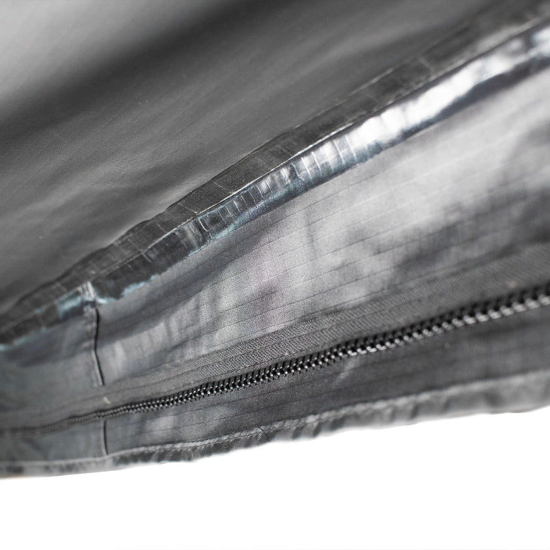 Close-up image of heat tape seam seal and zipper detail on Peregrine Pro 5-arm awning, black fabric with textured surface, detailed shot on white background