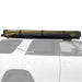 Image of Peregrine Pro 5-arm awning rolled up on white vehicle, black and green fabric, side view on white background