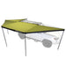 Image of Peregrine Pro 5-arm awning fully deployed, green fabric with black underside, angled front and top view on white vehicle with white background