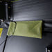 Close-up image of wire storage pocket inside Peregrine Pro 5-arm awning, green fabric with black underside, detailed shot on textured surface