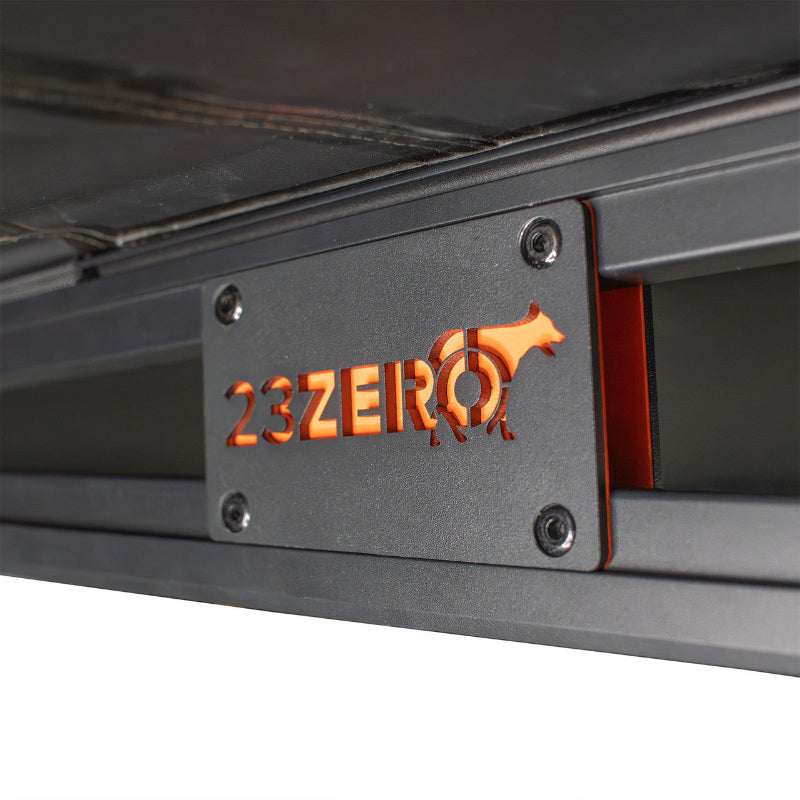 Close-up image of 23ZERO logo on Peregrine Pro 5-arm awning truss support, orange logo on black frame, detailed shot on white background