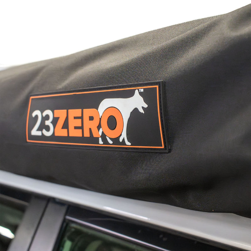 Close-up image of 23ZERO logo on Peregrine Pro 5-arm awning cover, black fabric with orange logo, detailed shot on white background