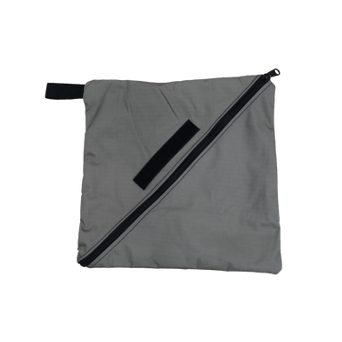 Image of 23ZERO upcycled soft shell repair material storage bag in grey fabric with black diagonal zipper and carry strap, front view on white background.