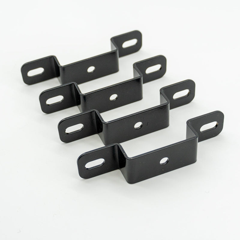 Image of four black powder-coated steel Z-shaped mounting brackets with slotted end holes and center round holes, angled front view on white background.