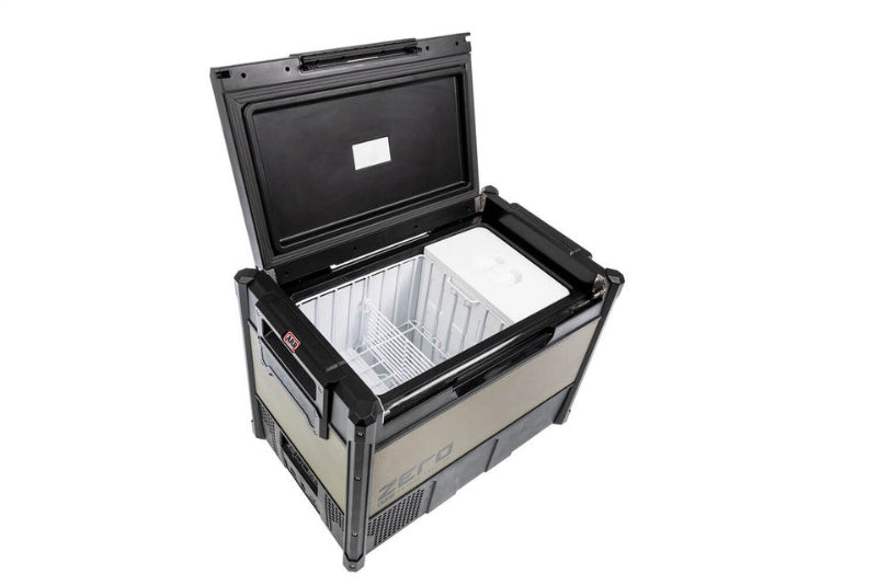 Image of ARB Zero Fridge Freezer with lid open, displaying a spacious interior with a white plastic insert and metal wire basket divider, angled top-down view on a white background.