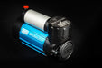 Image of an ARB Brushless 12V Air Compressor, blue and silver, angled from the front on a black background