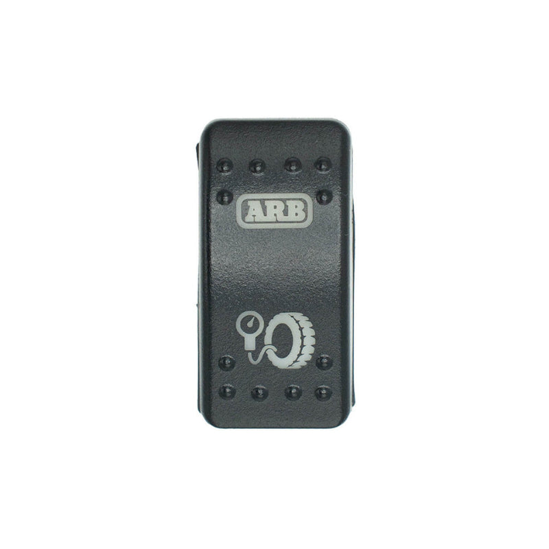 Image of a black ARB air compressor switch with an inflation gauge and tire icon, on a white background