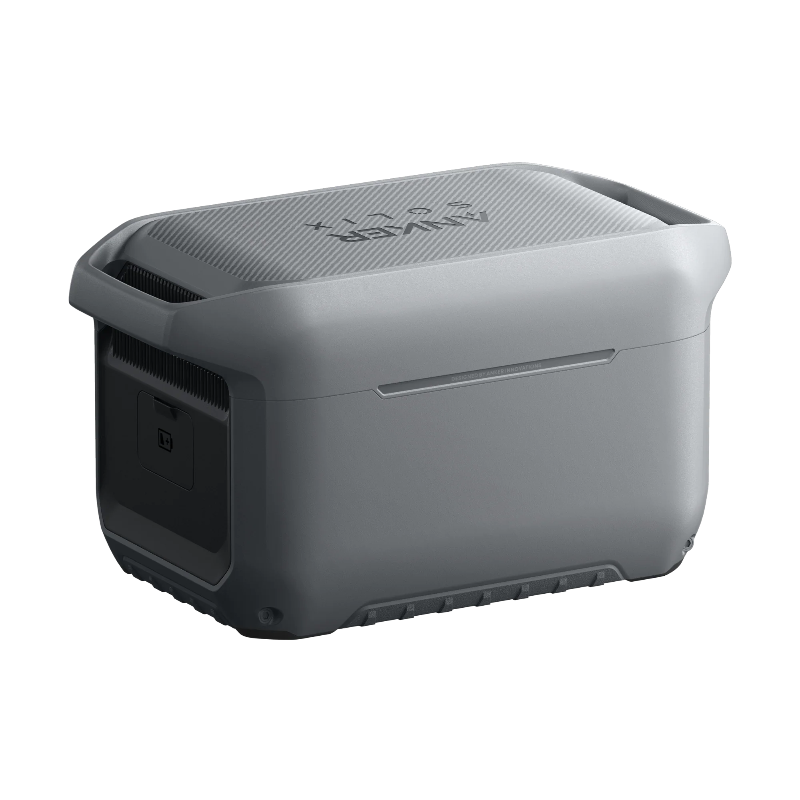 Image of Anker SOLIX portable power station with smooth gray rear panel and textured top surface, rugged compact design, angled rear and side view on black background.