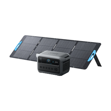 Image of Anker SOLIX portable power station placed in front of a foldable solar panel setup with integrated stand, digital display and AC outlets visible, rugged gray design, angled front view on black background.