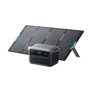 Image of Anker SOLIX portable power station positioned in front of a foldable solar panel array, digital display and multiple AC outlets visible, rugged gray design, angled front view on black background.