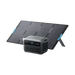 Image of Anker SOLIX portable power station positioned in front of a foldable solar panel array, digital display and multiple AC outlets visible, rugged gray design, angled front view on black background.