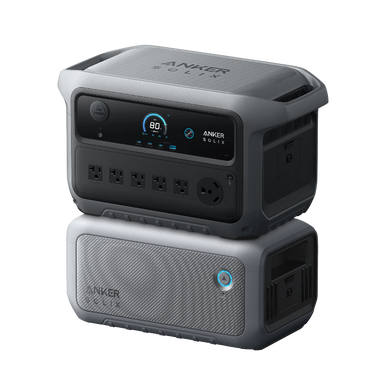 Image of Anker SOLIX portable power station stacked on expansion battery with illuminated control button, digital display and multiple AC outlets, rugged gray design, angled front and side view on black background.