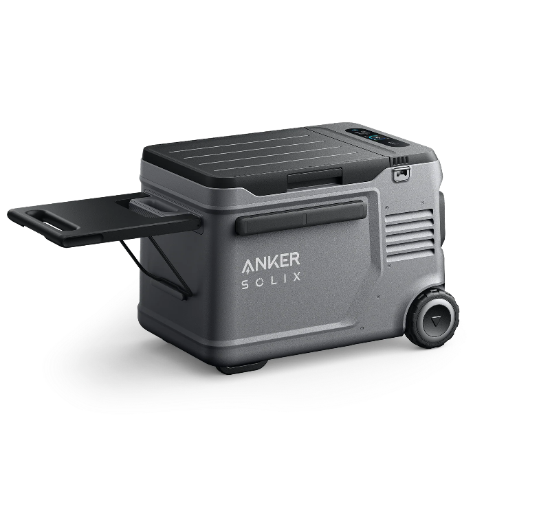 Image of Anker SOLIX portable electric cooler with slide-out tray, rugged gray body and built-in wheels, angled side and rear view on black background.
