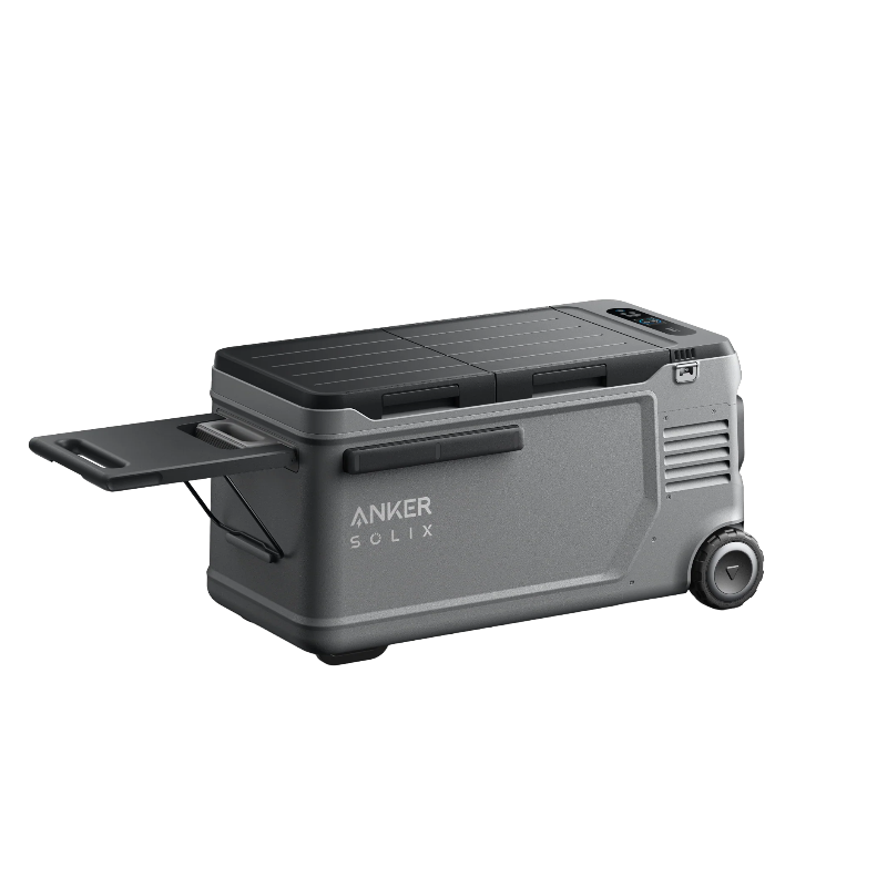 Image of Anker SOLIX EverFrost electric cooler with rugged gray body, closed lid, pull-out side tray, wheels and handle visible, angled front and side view on transparent background.