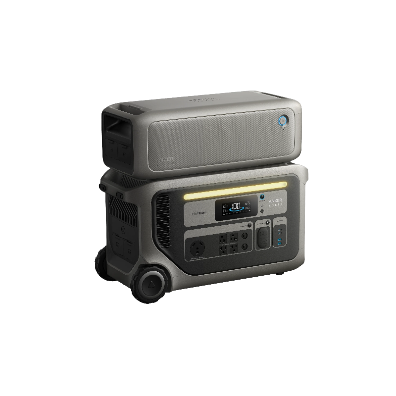 Image of Anker SOLIX F3000 portable power station with stacked expansion battery on top, illuminated LED light bar and front power ports visible, rugged gray wheeled design, angled front and side view on transparent background.