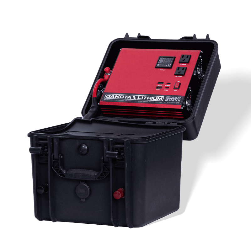 Image of an open black Dakota Lithium Powerbox 135 revealing a red 2000W Pure Sine Wave Inverter, angled front and side view on a dark background