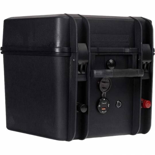 Image of the Dakota Lithium Powerbox 60, a portable battery box shown from a slight angle. The image highlights the various charging and power output ports on the front of the black case, including the USB ports and the 12V cigarette lighter outlet
