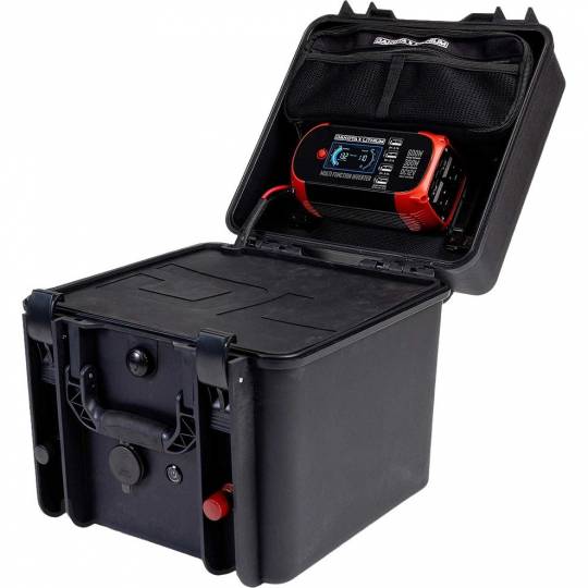 Image of the Dakota Lithium Powerbox 60, a portable battery box with the lid open, revealing a Dakota Lithium multi-function inverter and charger stored inside. The charger is red and black with an LCD screen, and is secured in a mesh pocket on the inside of the lid