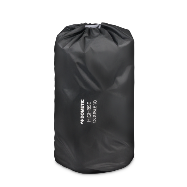 Image of a black Dometic High-Rise Double 10 sleeping pad rolled and stored in its black drawstring carry bag, on a light gray background.