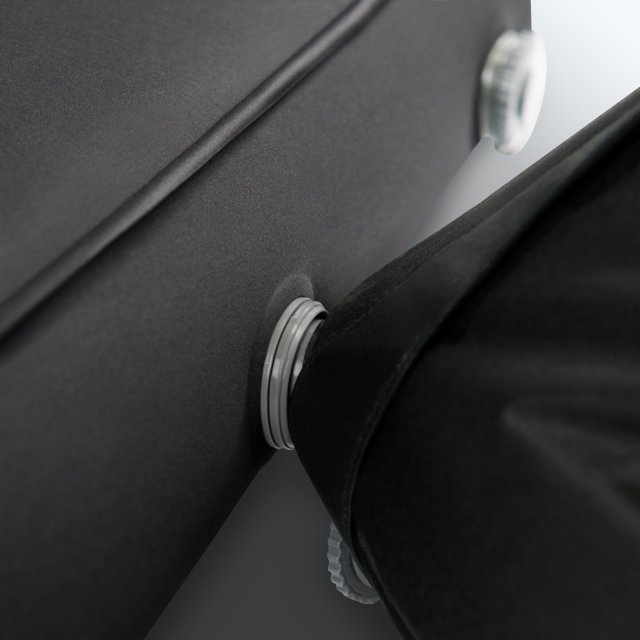 Image of a Dometic 15 High Self-Inflating Double Mattress, black, rolled up and secured with two grey straps, shown on a plain black background.